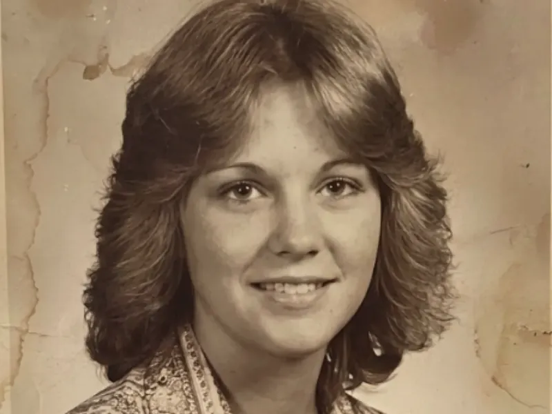 Faded, yellowed 1970s portrait before AI photo restoration