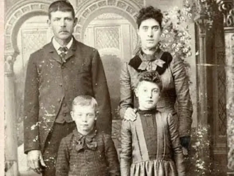 Old family portrait covered in spots and stains before AI photo restoration